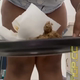 A black woman spreads her ass in close up from below as a soft, mushy load smears out of her ass. She wipes with paper, then shows off her pile on a metal tray at the end. Vertical format video. About a minute.